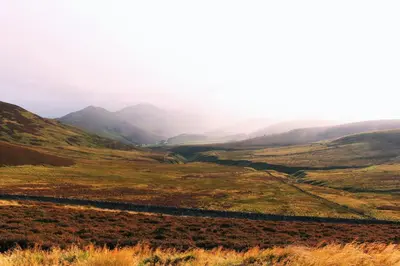 a view of a valley with mountains in the background at Beautiful and Bright Georgian Style Morningside Apartment - Pass the Keys in Edinburgh