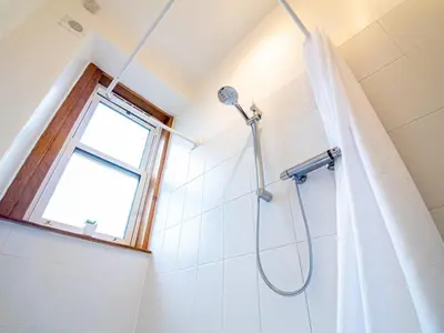 a bathroom with a shower with a window at Beautiful and Bright Georgian Style Morningside Apartment - Pass the Keys in Edinburgh