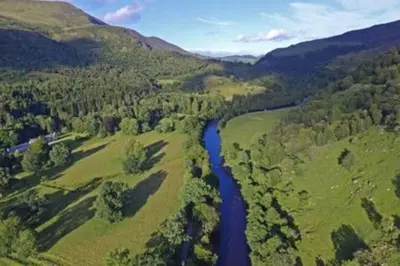 an aerial view of a river in a valley at Chesthill House and Estate, Glen Lyon in Aberfeldy
