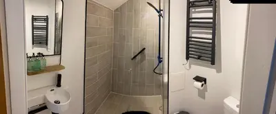 a bathroom with a shower with a toilet and a sink at The Colintraive in Colintraive