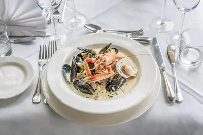 a plate of food with mussels on a table at Crinan Hotel in Crinan