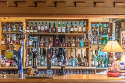 a bar filled with lots of bottles of alcohol at Crinan Hotel in Crinan