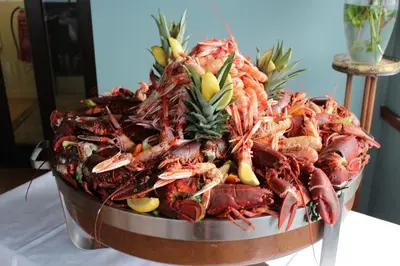 a large bucket of lobsters on a table at Crinan Hotel in Crinan