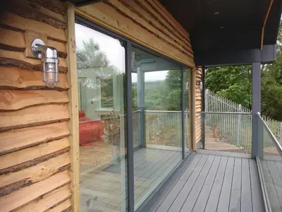 a screened porch with sliding glass doors on a house at Tidereach - Otters View in Connel