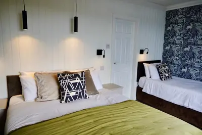 a bedroom with two beds with pillows on them at Lochnell Arms Hotel in Oban
