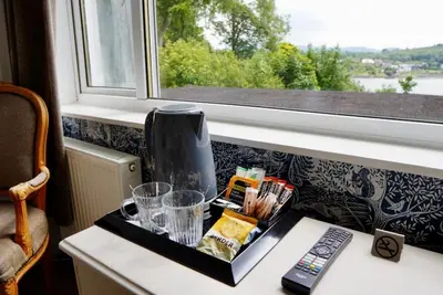 a tray of food on a table next to a window at Lochnell Arms Hotel in Oban