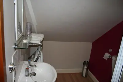 a bathroom with a sink and a mirror at Royal Hotel in Girvan