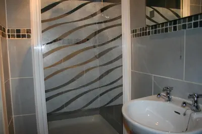 a bathroom with a shower and a sink at Royal Hotel in Girvan