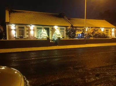 a house with christmas lights on the front of it at Shawlee Cottage in Airdrie
