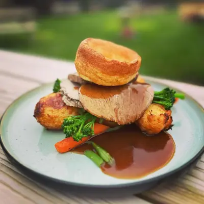 a plate of food with a sandwich and gravy at The Smiddy Haugh in Auchterarder