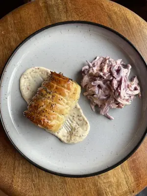 a plate of food with a sandwich and coleslaw at The Smiddy Haugh in Auchterarder