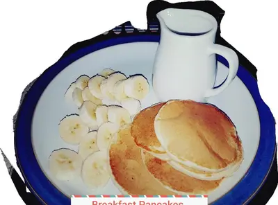 a plate with pancakes and bananas and a syrup bottle at St.Ebba B&B in Rothesay