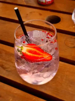 a drink with a strawberry and a spoon in it at St.Ebba B&B in Rothesay