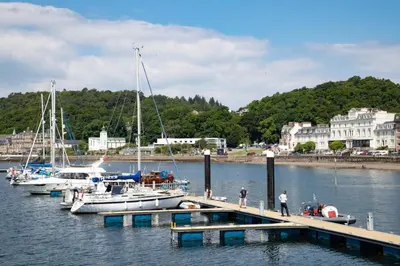 a group of boats docked at a dock in the water at The Great Western Hotel in Oban