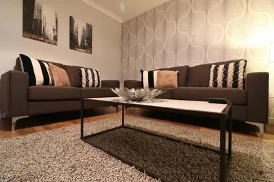 a living room with a couch and a coffee table at Signature - Stanfield House in Motherwell