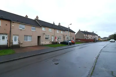 an empty street in a residential neighborhood with houses at Signature - Stanfield House in Motherwell