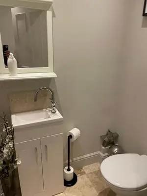 a bathroom with a white toilet and a sink at Stylish City Centre Apartment in Edinburgh