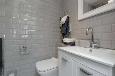 a white bathroom with a toilet and a sink at Elegant Flat Near Princes Street - Perfect Location, 24-7 Customer Support in Edinburgh
