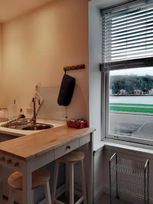 a kitchen with a counter with a sink and a window at Beside the Bay in Millport