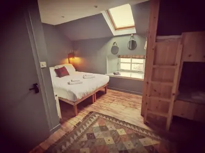 a small bedroom with a bed and a window at Comrie Croft in Crieff