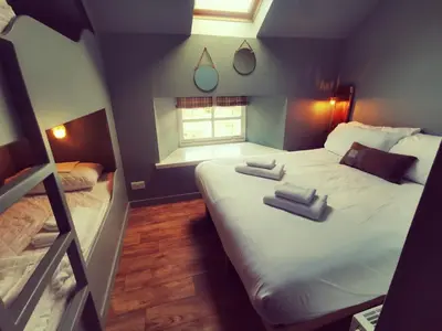 a bedroom with a large bed with towels on it at Comrie Croft in Crieff