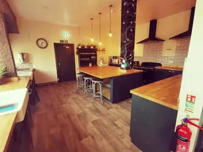 a kitchen with a large island with a wooden counter top at Comrie Croft in Crieff