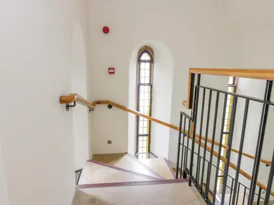 a staircase in a building with a window at Penthouse St Mary's Church in Moffat