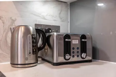two toaster and a coffee maker on a kitchen counter at Stunning 1 Bed Merchant City Apartment with Parking in Glasgow