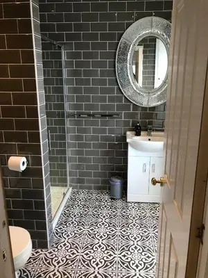 a bathroom with a sink and a mirror at Fasgadh Rooms in Tarbert