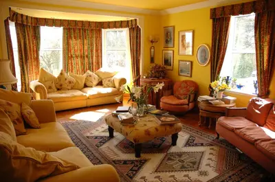 a living room with couches and a coffee table at Craigadam Country House Hotel in Kirkpatrick Durham