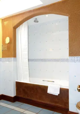 a bathroom with a tub and a mirror at Craigadam Country House Hotel in Kirkpatrick Durham