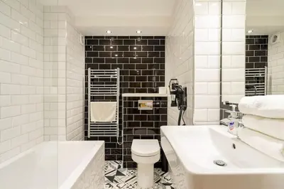 a bathroom with a toilet and a sink and a tub at Central, Bright 2 Bed Flat - Pool & Sauna in Edinburgh