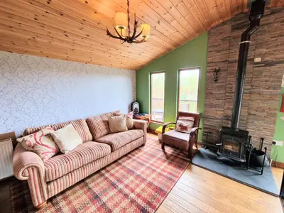 a living room with a couch and a fireplace at Torridon 1 with Private Hot Tub - Fife - Loch Leven - Lomond Hills- Pet Friendly in Kelty