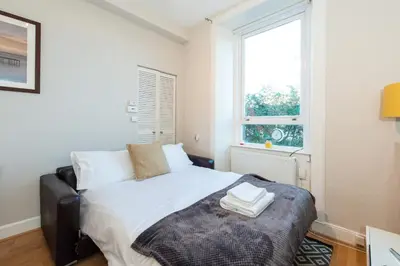 a bedroom with a bed and a window at The Westfield in Edinburgh
