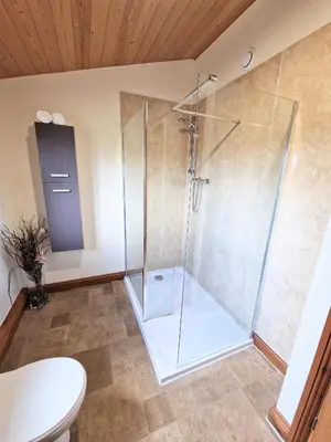 a shower with a glass door in a bathroom at Ochil 8 with Private Hot Tub - Fife - Loch Leven - Lomond Hills in Kelty