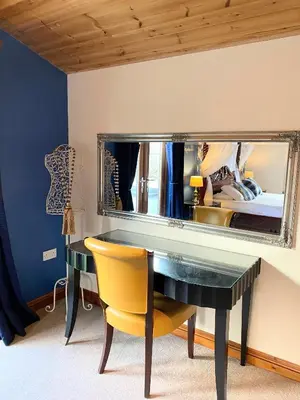 a bedroom with a desk and a mirror at Lomond 5 with Private Hot Tub - Fife - Loch Leven - Lomond Hills - Pet Friendly in Kelty