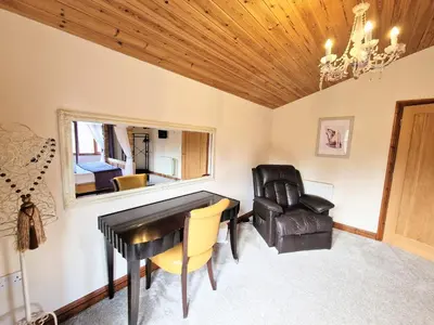 a room with a desk and a chair and a chandelier at Lomond 6 with Private Hot Tub - Fife - Loch Leven - Lomond Hills in Kelty