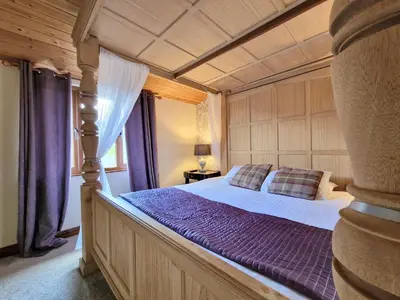 a bedroom with a large bed with purple sheets at Lomond 6 with Private Hot Tub - Fife - Loch Leven - Lomond Hills in Kelty