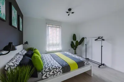 a bedroom with a bed and a window at RelaxingSleep Apartments in Glasgow