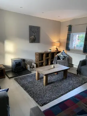 a living room with a coffee table and a couch at Garron House in Auchterarder