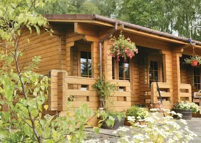 a log cabin with a flower hanging from it at Cosy & compact Rowan Lodge no4 in Killin