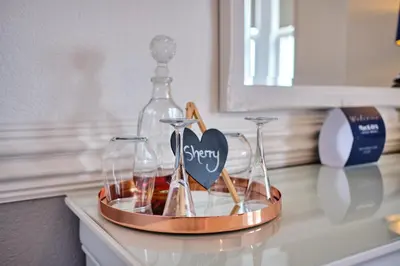 a tray with two wine glasses and a bottle on a counter at MacKays in Oban