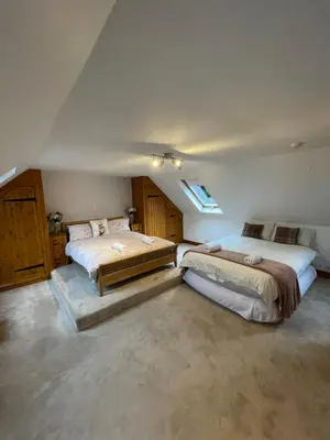 a bedroom with two beds in a room at Amazing Alps and Loch views - HOT TUB and pet friendly in Arrochar