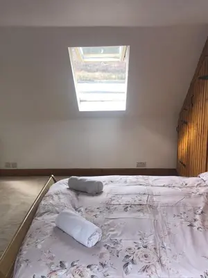 a bedroom with a bed with two pillows on it at Amazing Alps and Loch views - HOT TUB and pet friendly in Arrochar