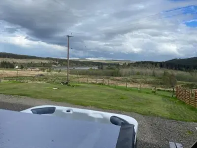 a car is parked on the side of the road at Carminnows Holiday Cottage in Carsphairn