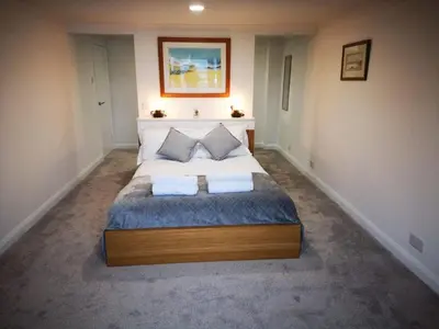 a bedroom with a large bed with two pillows at Imperial Apartment in Oban