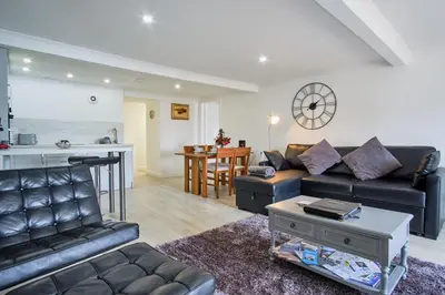 a living room with a couch and a table at Imperial Apartment in Oban