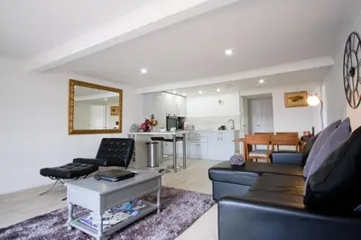 a living room with a couch and a table at Imperial Apartment in Oban
