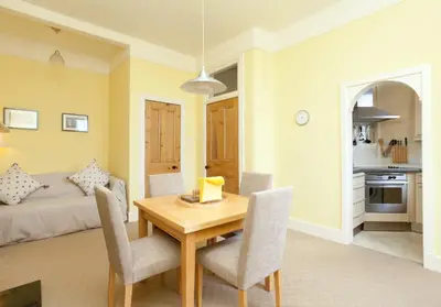 a living room with a table and chairs and a couch at Mardale Crescent - 380 in Edinburgh