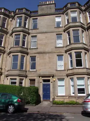 a large stone building with a blue door at Mardale Crescent - 380 in Edinburgh